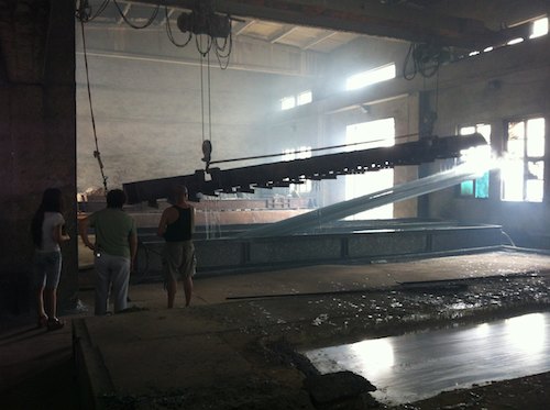 Angle Iron Plunged Into a Bath of Water to Cool Down Post Galvanization