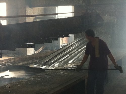 Workers Scooping the Dregs off the Surface of the Molten Zinc
